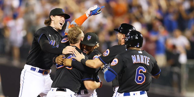 Pete Alonso #20 of the New York Mets celebrates with Francisco Lindor #12 and Brett Baty #22 after hitting a walk-off single in the bottom of the ninth inning to defeat the Colorado Rockies 7-6 at Citi Field on August 26, 2022 in New York City.