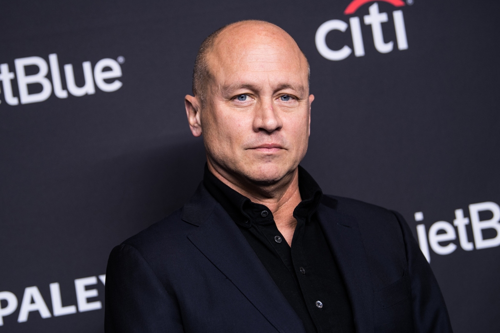 Photo of series creator Mike Judge. He's wearing a blue sports jacket and a black sports shirt. He's looking at the camera directly.