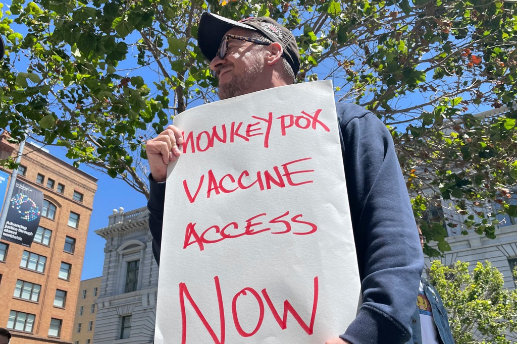 A man holds a sign urging increased access to the monkeypox vaccine during a protest in San Francisco, July 18, 2022. California's governor on Monday, Aug. 1, 2022, declared a state of emergency to speed efforts to combat the monkeypox outbreak, becoming the second state in three days to take the step. (AP Photo/Haven Daley, File)