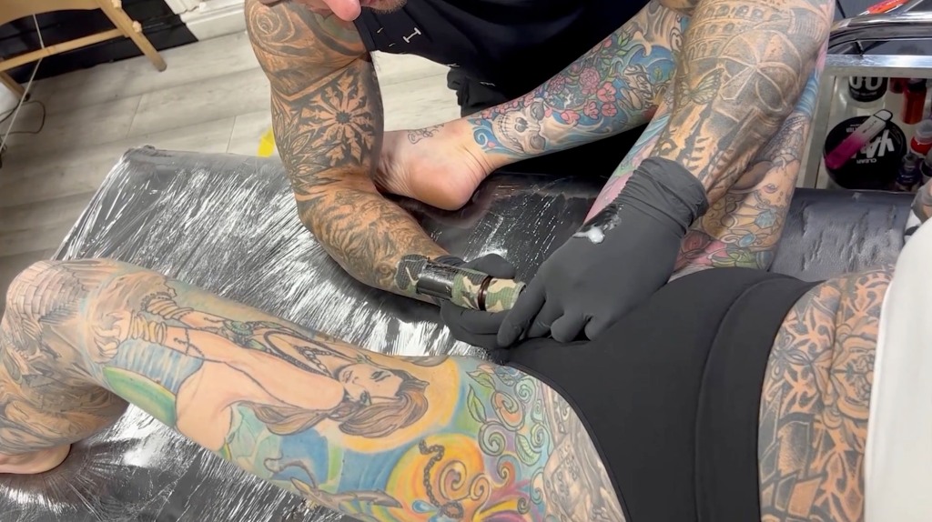 "It’s quite embarrassing having a tattoo artist between your legs," Holt admitted. 