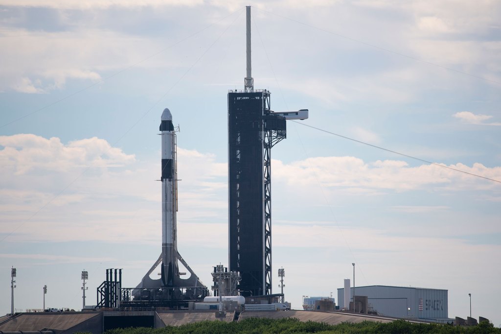 In this image released by NASA, a SpaceX Falcon 9 rocket with the company's Crew Dragon spacecraft stands upright after it was raised raised into a vertical position on the launch pad at Launch Complex 39A, Wednesday, Oct. 27, 2021, at the Kennedy Space Center in Cape Canaveral, Fla