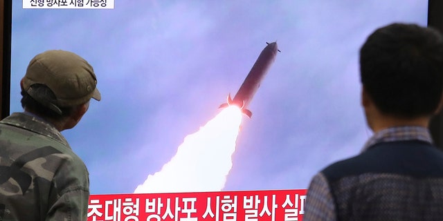 People watch a TV showing a file image of an unspecified North Korea's missile launch during a news program at the Seoul Railway Station in Seoul, South Korea, Thursday, Oct. 31, 2019. 