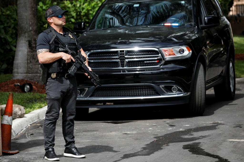 A Secret Service officer stands guard outside former U.S. President Donald Trump's Mar-a-Lago home after an FBI raid earlier this week.
