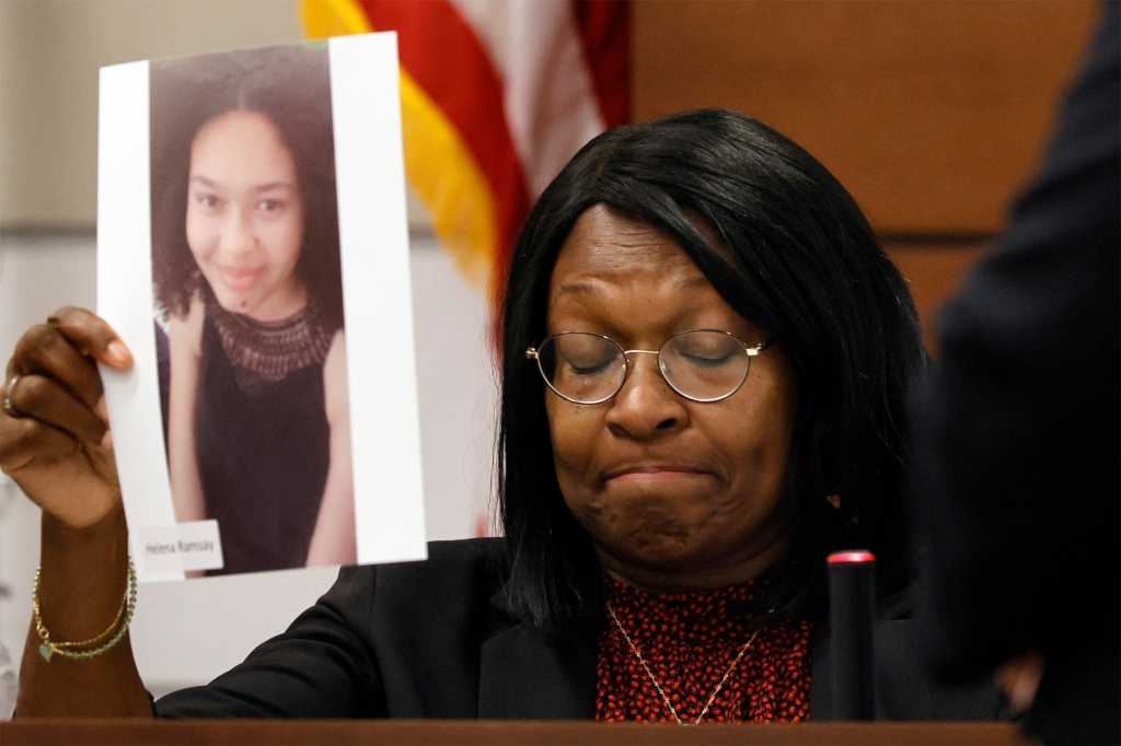 Anne Ramsay holding up a photo of her daughter Helena, a victim of the Parkland shooting, at Cruz's trial on August 4, 2022.