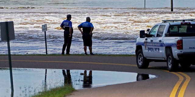 Reservoir police observe the water release from the Ross Barnett Reservoir Spillway onto the Pearl River, Sunday, Aug. 28, 2022, in Rankin County, Miss.