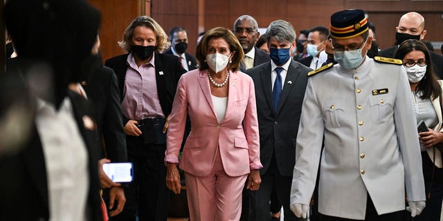 This handout photo taken and released by Malaysia’s Department of Information, U.S. House Speaker Nancy Pelosi, center, tours the parliament house in Kuala Lumpur, Tuesday, Aug. 2, 2022. 