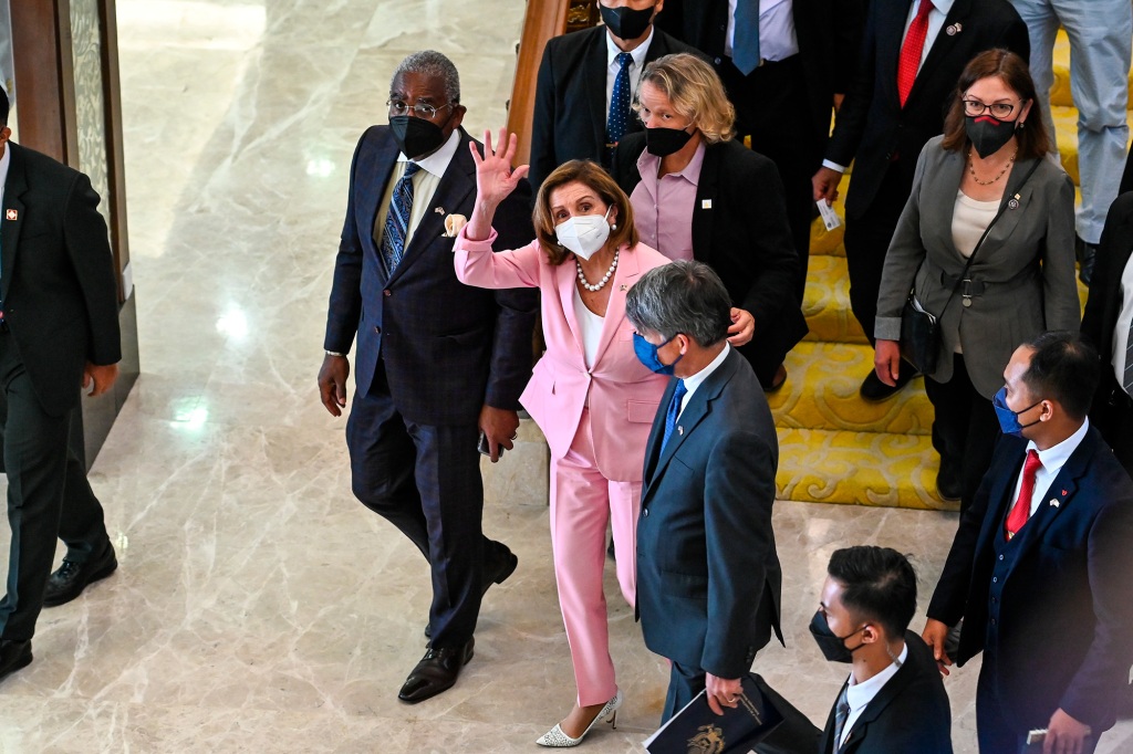 This handout photo taken and released by Malaysia’s Department of Information, U.S. House Speaker Nancy Pelosi, center, waves to media as she tours the parliament house in Kuala Lumpur, Tuesday, Aug. 2, 2022. Pelosi arrived in Malaysia on Tuesday for the second leg of an Asian tour that has been clouded by an expected stop in Taiwan, which would escalate tensions with Beijing. (Malaysia’s Department of Information via AP)