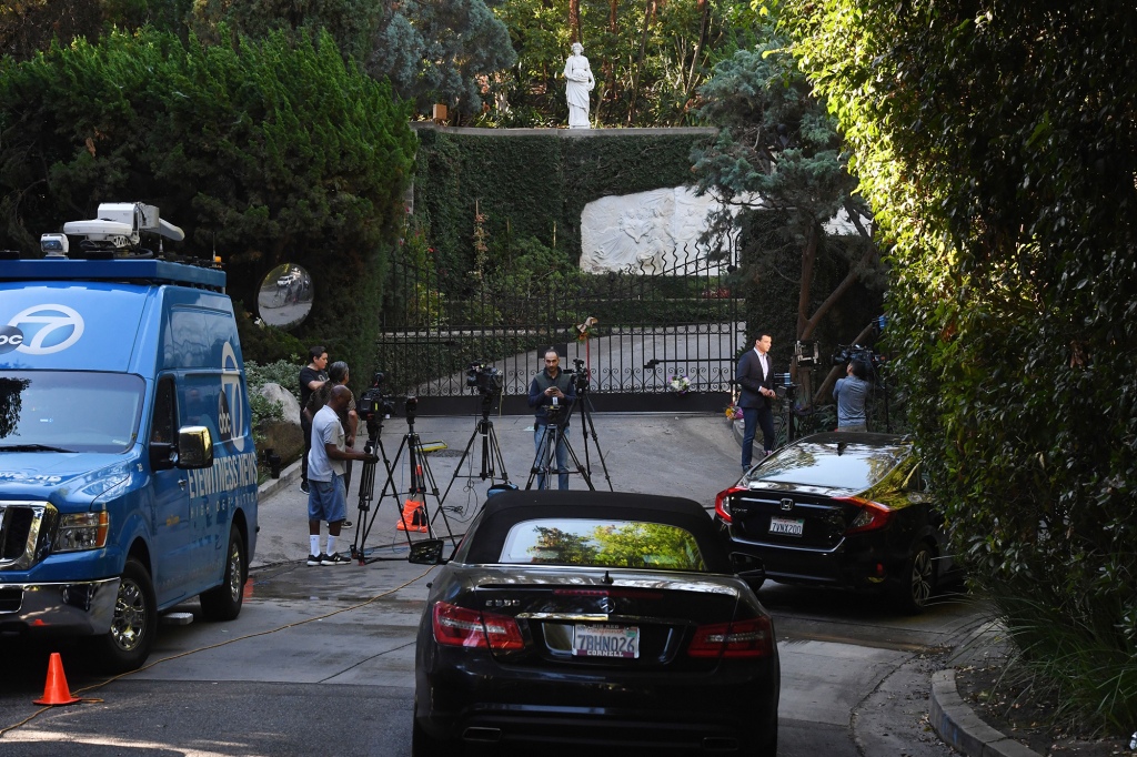 News cameras outside the gates of the Playboy mansion after Hefner's death in 2017.