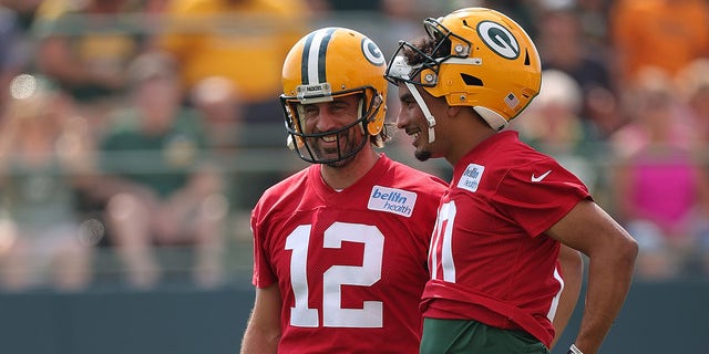 Aaron Rodgers, left, and Jordan Love of the Green Bay Packers work out during training camp at Ray Nitschke Field in Ashwaubenon, Wisconsin, on July 29, 2021.