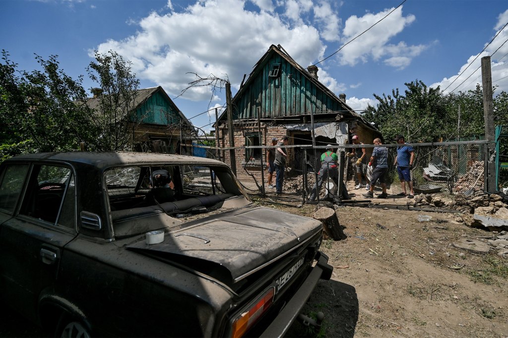 Men remove the rubble at a house ruined as a result of Russian shelling, Nikopol, Dnipropetrovsk Region, central Ukraine.