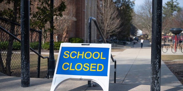 A "closed" sign in front of a public elementary school in Grand Rapids, Michigan in March 2020. 