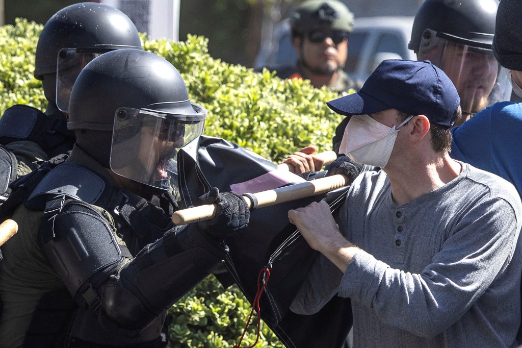 Counter-protesters clash with local police after a confrontation with Straight Pride Parade attendees at a rally outside a Planned Parenthood office in Modesto, California, U.S., August 27, 2022. 