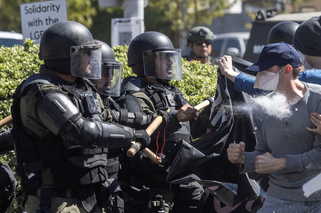 Counter-protesters clash with local police after a confrontation with Straight Pride Parade attendees at a rally outside a Planned Parenthood office in Modesto, California, U.S., August 27, 2022. 