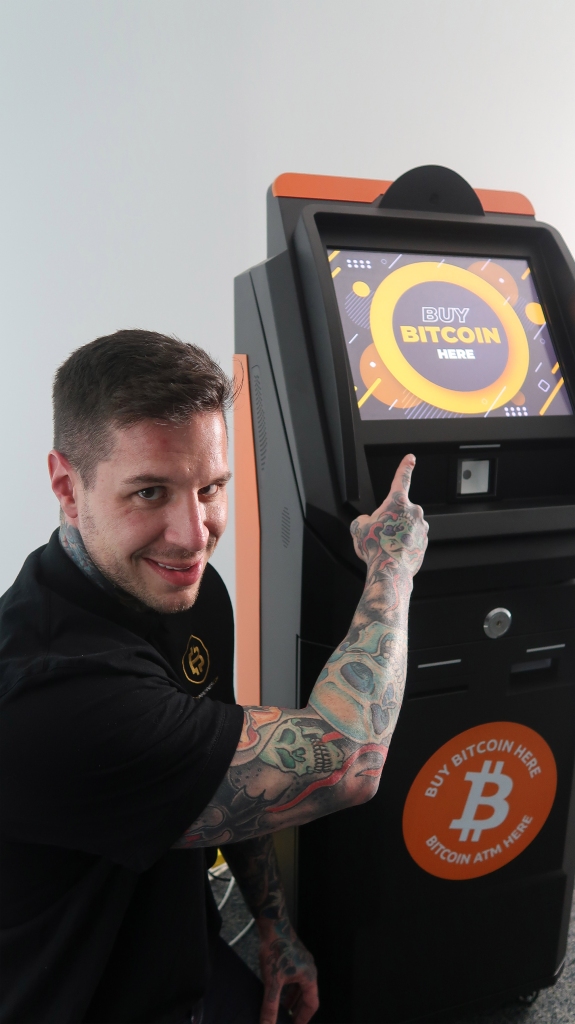 Justin Gilmore with a Bitcoin ATM