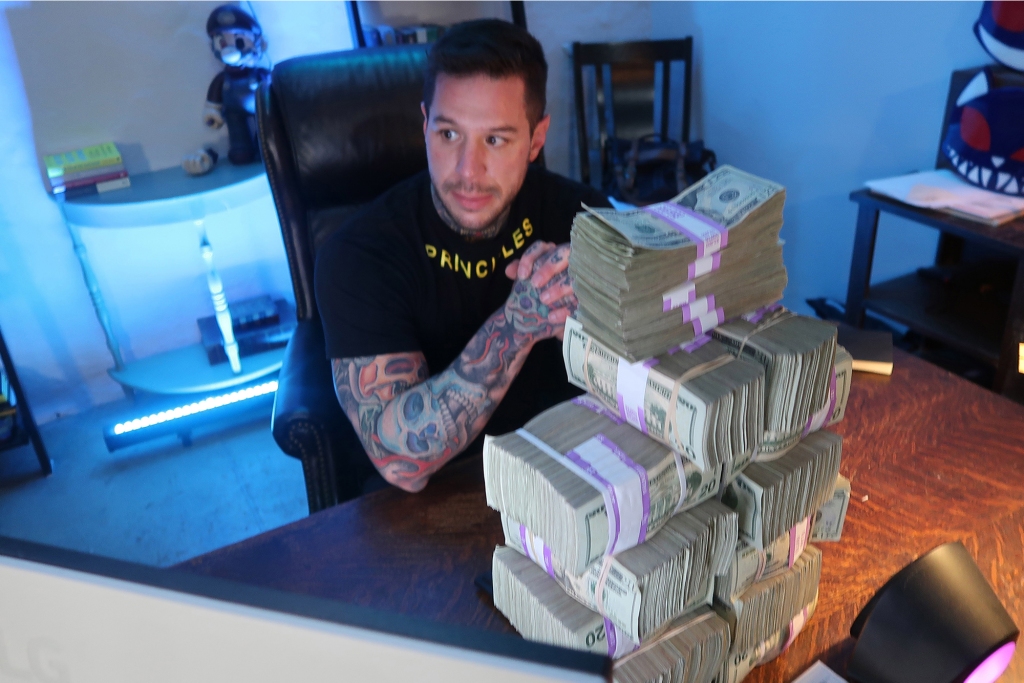 Justin Gilmore with a stack of cash