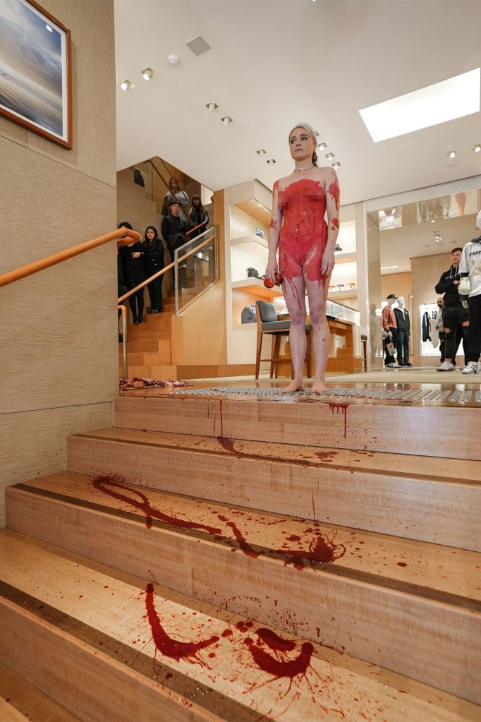 Vegan activist Tash Peterson protesting at a Louis Vuitton store.