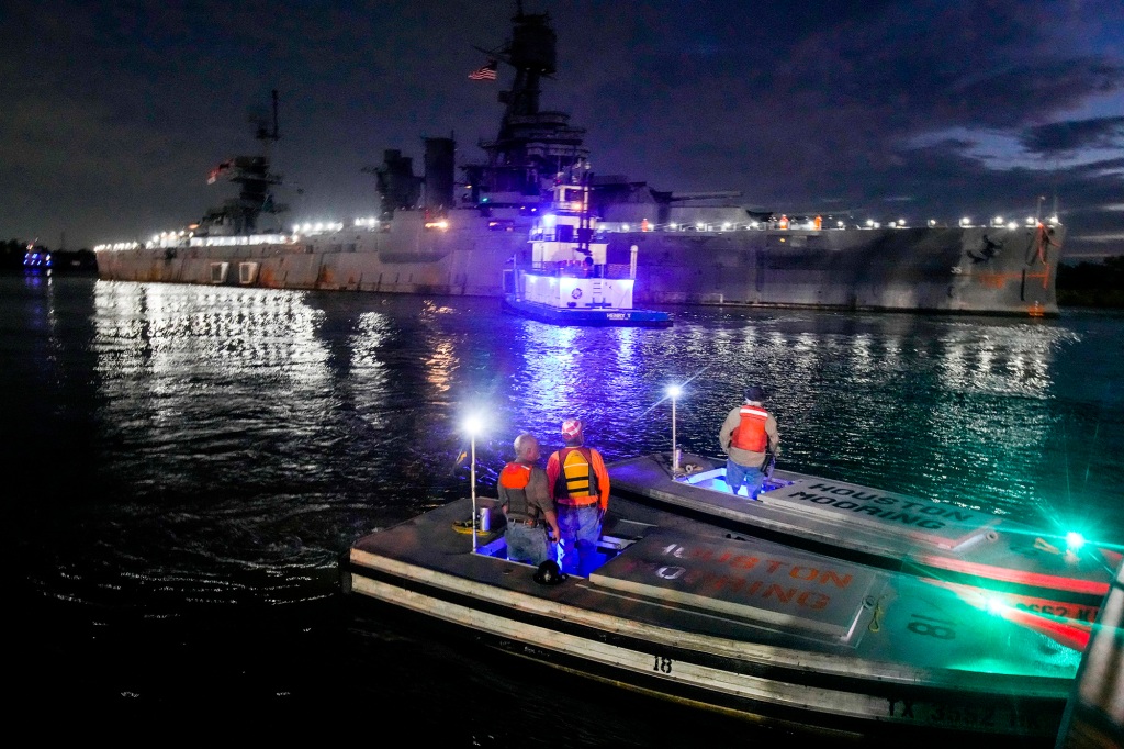 Tugboats eased the more than 100 year-old ship out of its slip in La Porte, Texas before dawn.