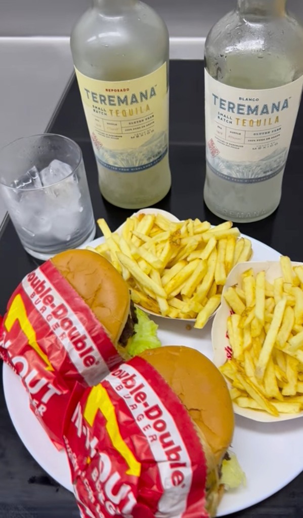 Dwayne 'The Rock' Johnson indulges in a hefty 'cheat meal' including two large burgers and a bottle of TEQUILA after his workout