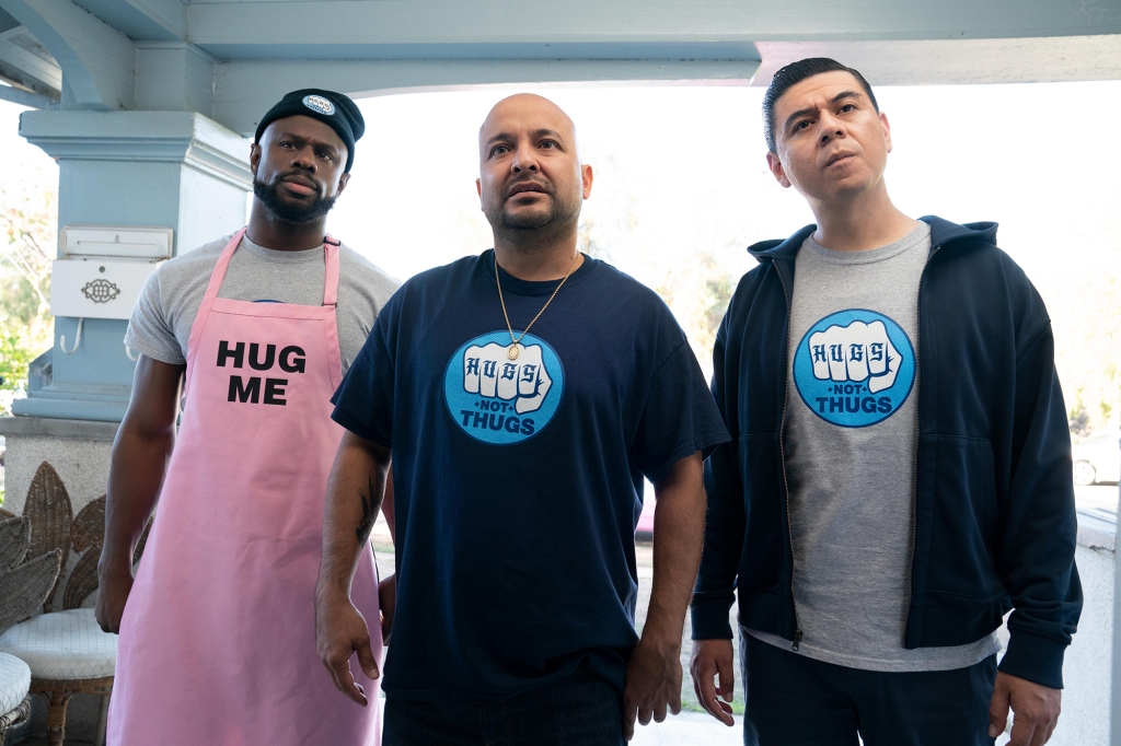 Jamar Malachi Neighbors, Frankie Quiñones and Chris Estrada in "This Fool," premiering Aug. 12 on Hulu. Neighbors is wearing a pink apron that says "Hug Me" on it. The other two are wearing T-shirts that say "Hugs Not Thugs."