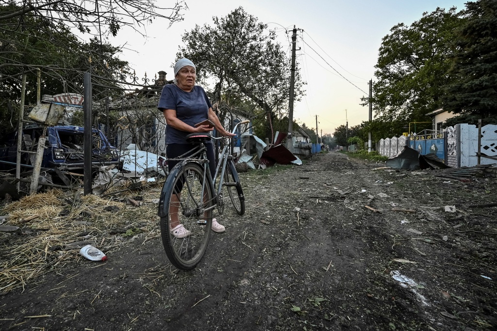 A woman stands near residential houses destroyed by a Russian military strike, as Russia's attack on Ukraine continues, in Chaplyne, Dnipropetrovsk region, Ukraine on August 24, 2022.