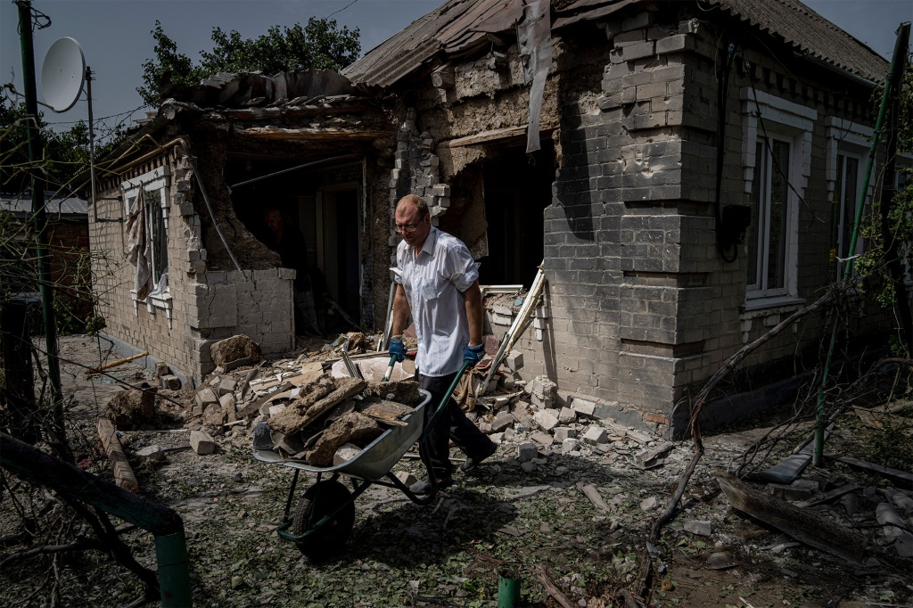 A man clearing rubble from his home in Nikopol, Ukraine after Russian bombing on August 22, 2022.
