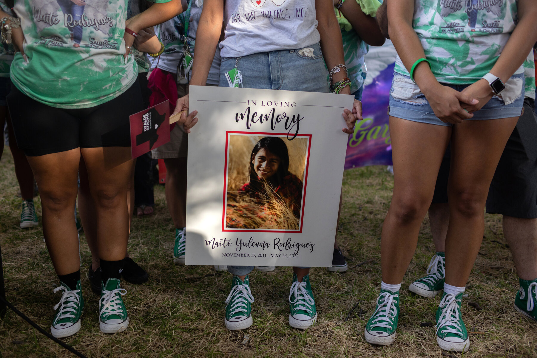 Ana Rodriguez, the mother of Maite Rodriguez, who was killed in the shooting, at the rally with family members who wore green Converse shoes with hearts drawn on the right toe. They were similar to the shoes Maite had on when she died.