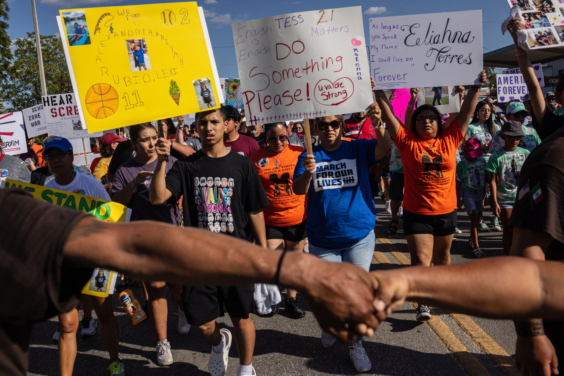 Uvalde residents and family members of those killed in the Robb Elementary School shooting march from the school to Uvalde’s town square.