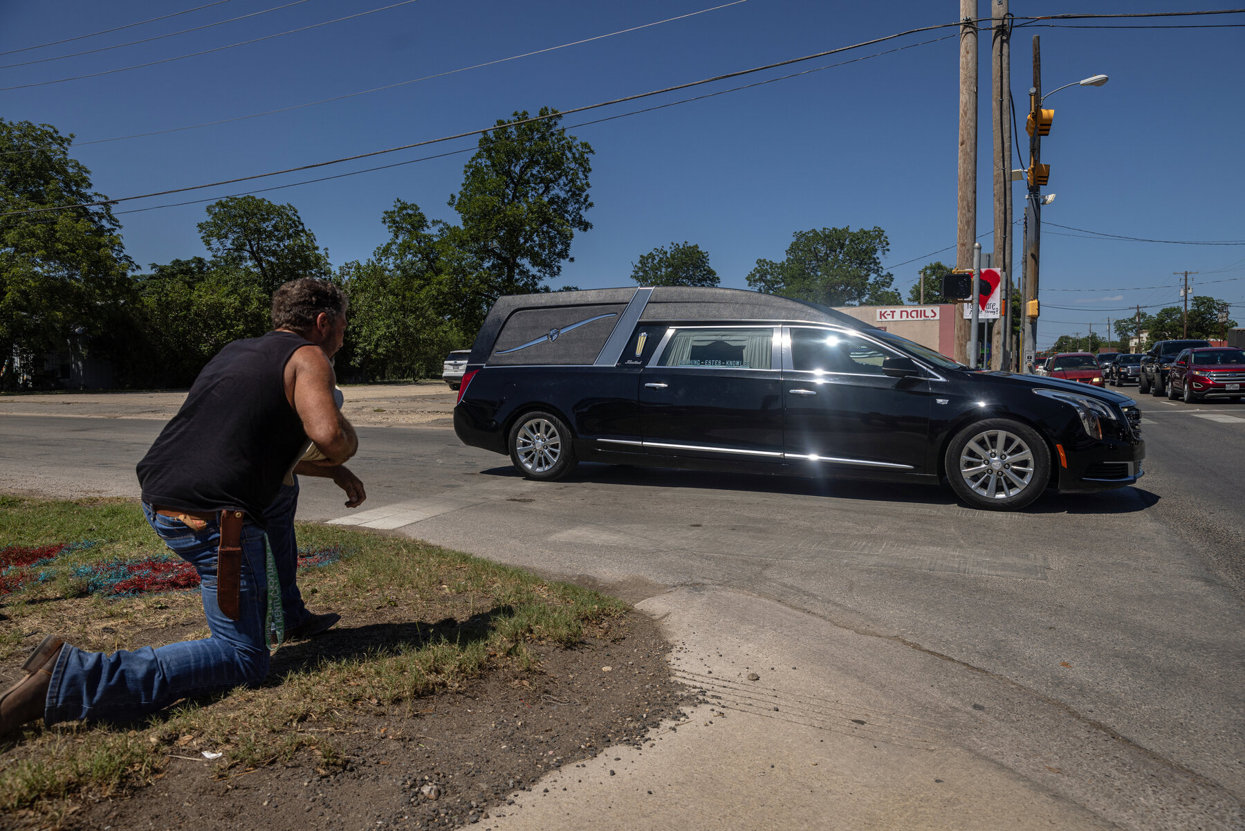 Dave Graham paid his respects as the funeral procession for Rojelio Torres, 10, drove by him. Mr. Graham came to Texas from Ohio to offer emotional support to members of the community. “I wanted to make a place for people where they could be safe,” he said, “where they could cry or they could yell or they could ask why.”