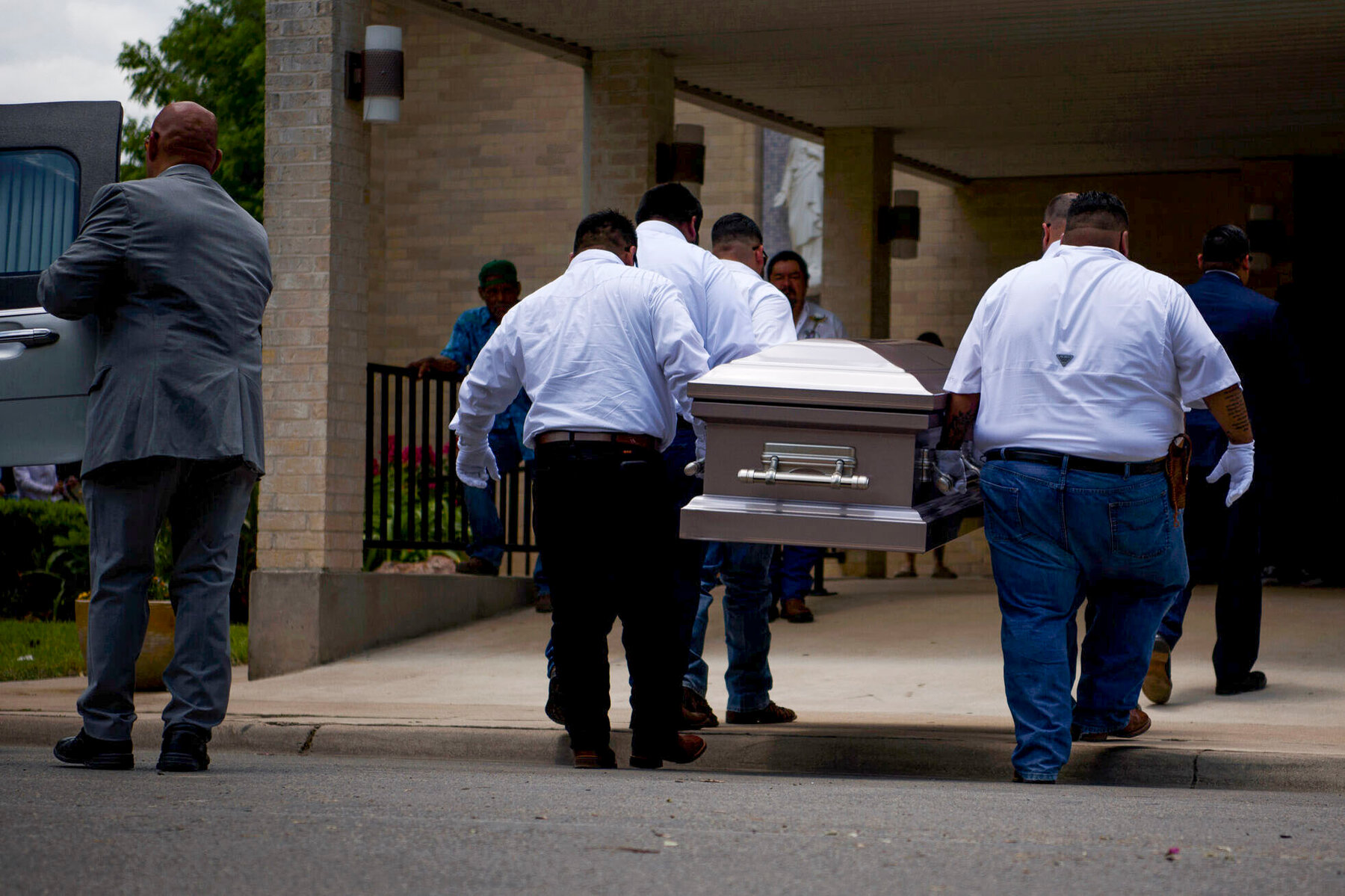 Pallbearers carried the casket of Amerie Jo Garza into Sacred Heart Catholic Church.