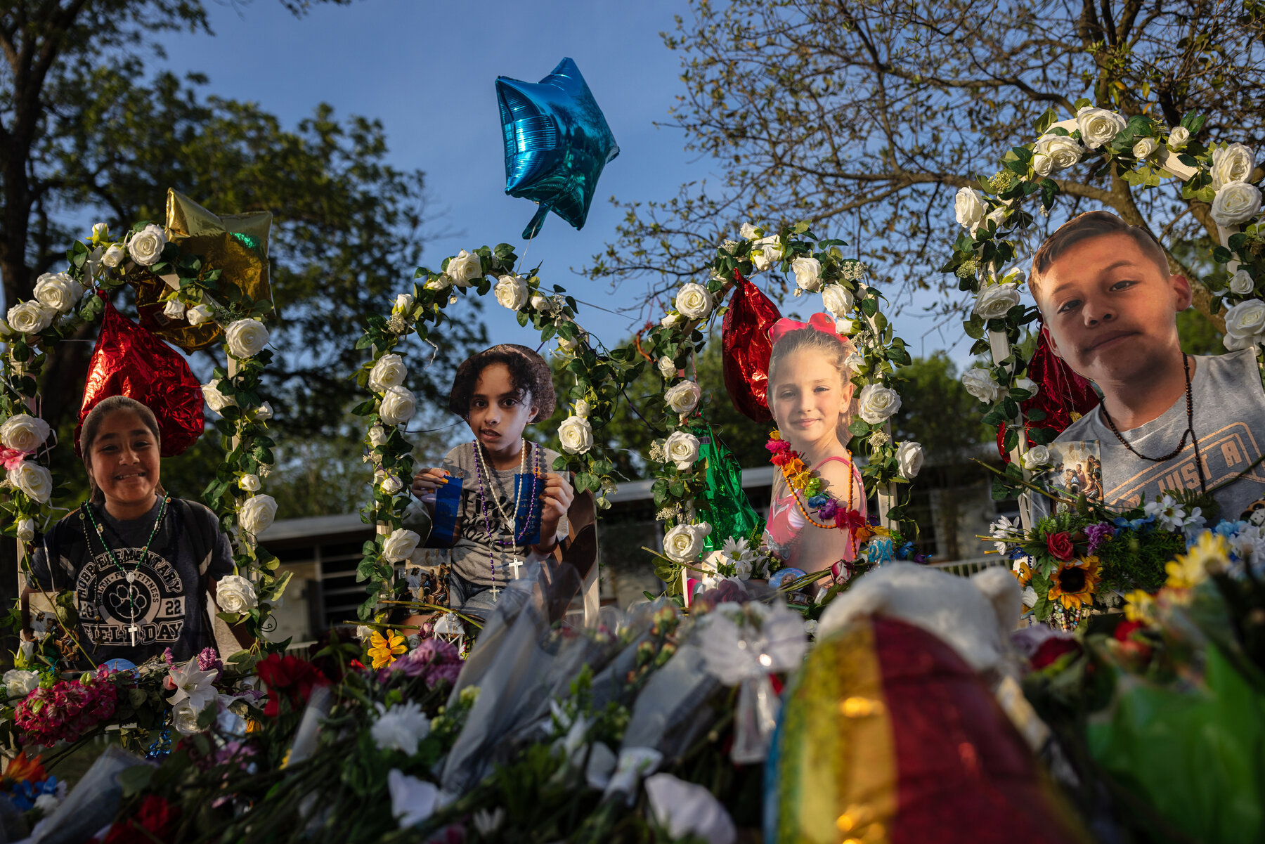 A memorial outside Robb Elementary School was filled with pictures of the victims, flowers, crosses, candles and hand-written notes.