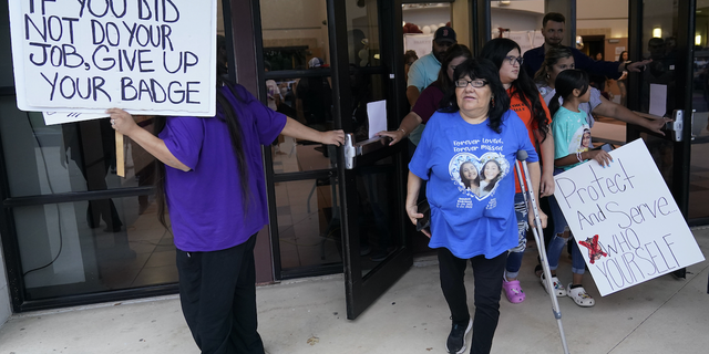 Family, parents and friends file out of a meeting where Uvalde School District Police Chief Pete Arredondo was dismissed by the Board of Trustees of the Uvalde Consolidated Independent School District, Wednesday, Aug. 24, 2022, in Uvalde, Texas. 