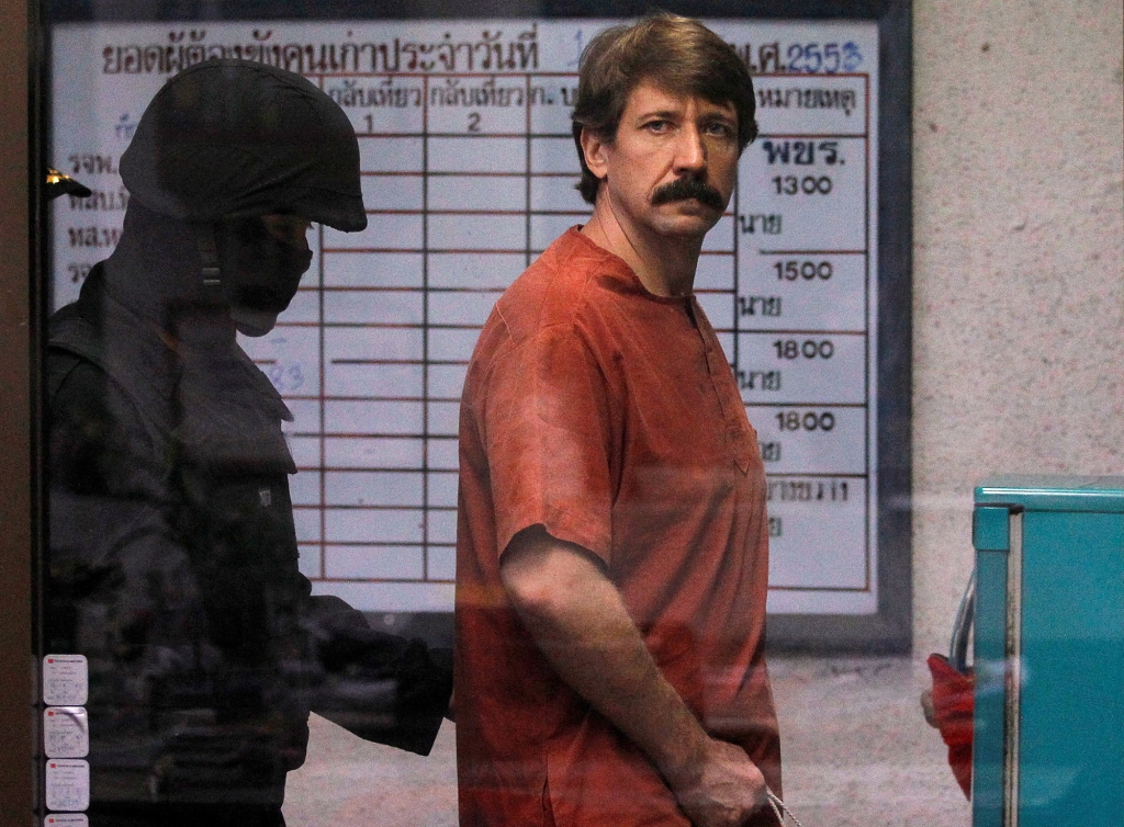 Viktor Bout from Russia is escorted by a member of the special police unit as he arrives at a criminal court in Bangkok October 4, 2010.