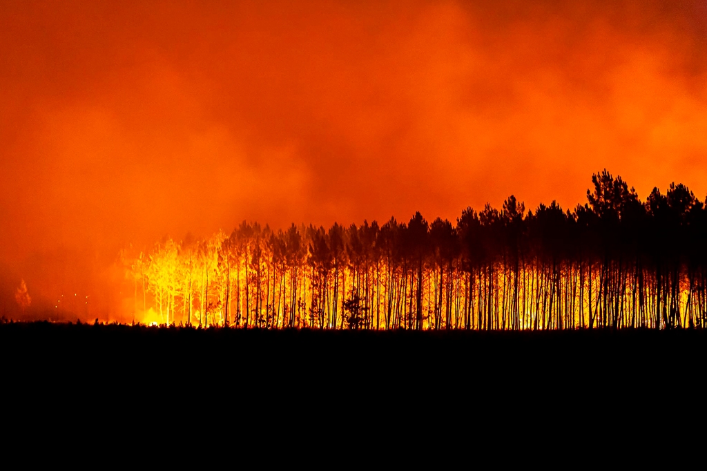 This photo provided by the fire brigade of the Gironde region SDIS 33, (Departmental fire and rescue service 33) shows a wildfire burning near Saint-Magne, south of Bordeaux, southwestern France, Aug. 12, 2022.