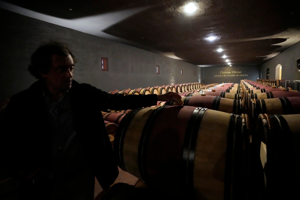 Laurent Lebrun, director of the Château Olivier Grand Cru Classe de Graves estate, shows barrels of red wine in the cellar, in Leognan, south of Bordeaux, southwestern France.