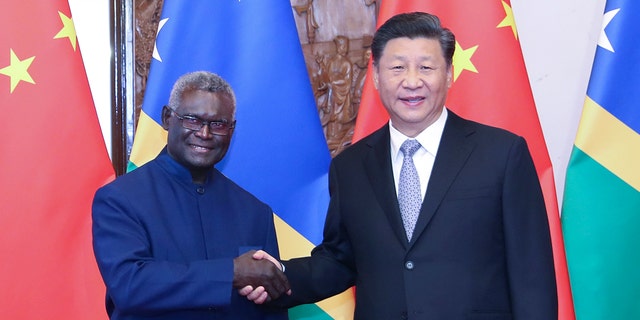 Chinese President Xi Jinping meets with Solomon Islands' Prime Minister, Manasseh Sogavare, in Beijing on Oct. 9, 2019.