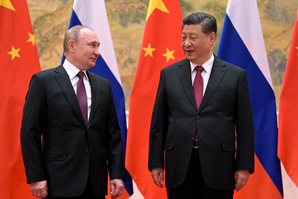 Chinese President Xi Jinping, right, and Russian President Vladimir Putin talk to each other during their meeting in Beijing, China, on Feb. 4, 2022.