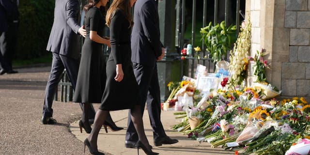 The Prince and Princess of Wales view the tributes left after the Death of Queen Elizabeth II, at Windsor Castle, Sept. 19, 2022. 