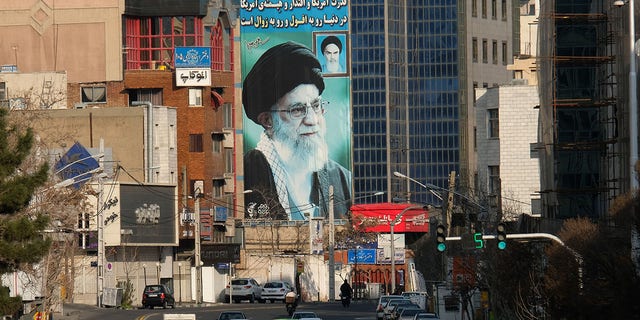 March 08, 2020: A huge mural of Ayatollah Seyyed Ali Khamenei Iran's Supreme Leader painted next to a smaller one of Ayatollah Ruhollah Khomeini (R) seen on Motahari street on March 8, 2020, in Tehran, Iran. The message on the wall reads "The power and influence and dignity of America in the world is on the fall and extermination" and on top of the building, another slogan reads "We are standing till the end".