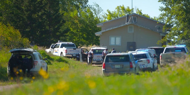 In this image taken from video, Canadian law enforcement personnel surrounded a residence on the James Smith Cree First Nation reservation in Saskatchewan, Canada, Tuesday, Sept. 6, 2022, as they search for a suspect in a series of stabbings. 