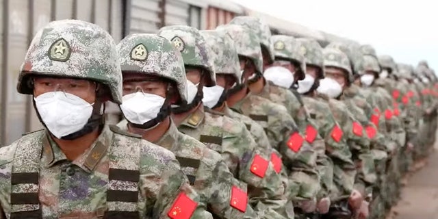 In this handout photo taken from video released by Russian Defense Ministry Press Service on Monday, Aug. 29, 2022, Chinese soldiers arrive to the Grodekovo railway station to participate in war games drills, in Grodekovo, Primorsky Krai, Russia. 