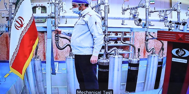 An engineer performs a mechanical test on nuclear equipment as President of Iran, Hassan Rouhani attends opening ceremony of nuclear projects in different regions of the country via video conference on 11th anniversary of National Nuclear Technology Day in Tehran, Iran on April 10, 2021.