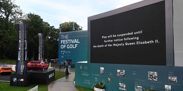 A screen displays the announcement that play is to be suspended following the death of Her Majesty Queen Elizabeth II during the BMW PGA Championship at Wentworth Golf Club Sept. 8, 2022, in Virginia Water, England. 