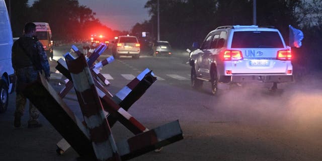 UN vehicles transporting members of International Atomic Energy Agency (IAEA) inspection mission drive on a road outside Zaporizhzhia city, after their visit to the Russian-held Zaporizhzhia nuclear power plant in southern Ukraine on Sept. 1, 2022, amid the Russian invasion of Ukraine. 