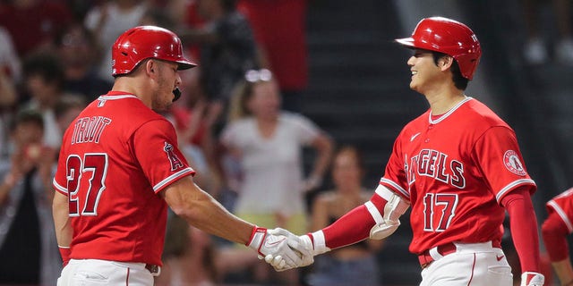 Shohei Ohtani #17 of the Los Angeles Angels celebrates his two-run home run with Mike Trout #27 in the third inning against the Detroit Tigers at Angel Stadium of Anaheim on September 05, 2022 in Anaheim, California.