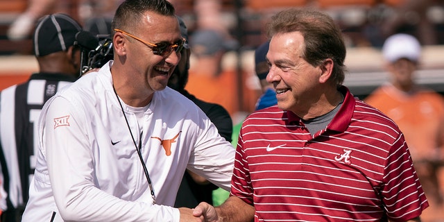 Texas head coach Steve Sarkisian, left, and Alabama head coach Nick Saban meet on the field during team warmups before a game Sept. 10, 2022, in Austin, Texas. 