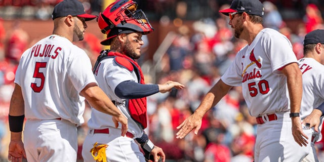 Albert Pujols (5), Yadier Molina (4) and Adam Wainwright (50) of the St. Louis Cardinals celebrate after a game at Busch Stadium Aug. 4, 2022, in St. Louis.