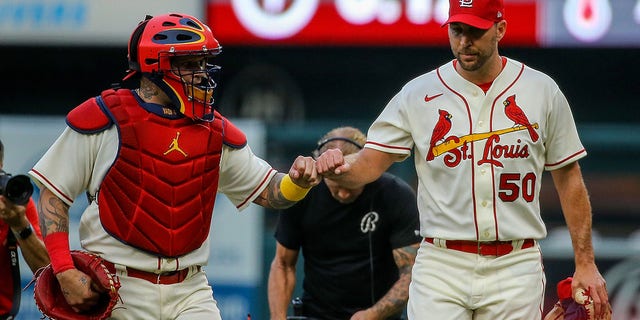 Yadier Molina and Adam Wainwright (50) of the St. Louis Cardinals fist bump as they walk to the dugout prior to a game against the Chicago Cubs at Busch Stadium Sept. 3, 2022 in St. Louis.