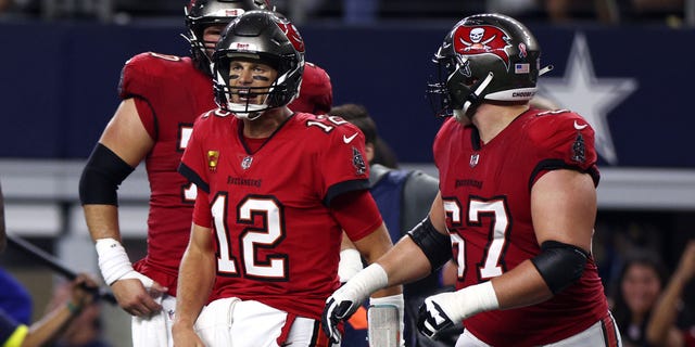 Tom Brady (12) of the Tampa Bay Buccaneers celebrates after throwing a touchdown pass to Mike Evans during the second half against the Dallas Cowboys Sept. 11, 2022, in Arlington, Texas.