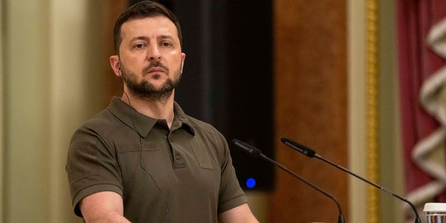 Ukrainian President Volodymyr Zelenskyy stands at the podium during a news conference in Kyiv, July 3, 2022.