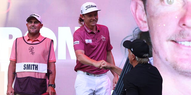 Greg Norman, CEO and commissioner of LIV Golf, presents team captain Cameron Smith of Punch GC with the trophy after he won the individual title of the LIV Golf Invitational - Chicago at Rich Harvest Farms Sept. 18, 2022, in Sugar Grove, Ill. 